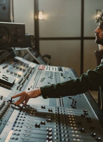 side view of concentrated sound producer working at studio